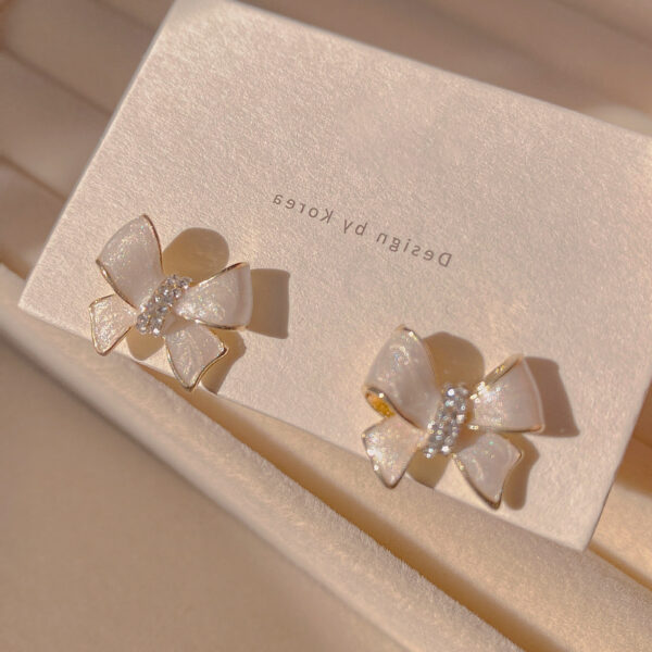 Tiny White Bow Earrings - Image 2